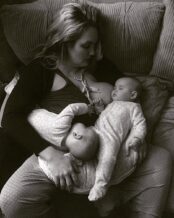 Photo of mom asleep under her sleeping twins while breastfeeding. Credit to Jennifer Mancuso